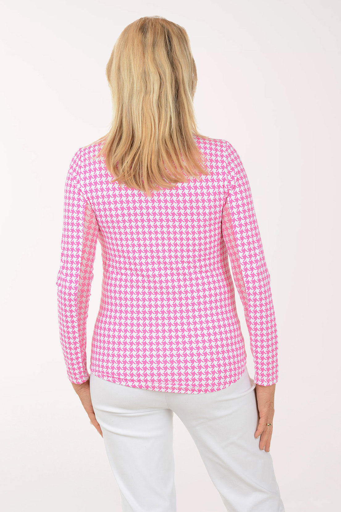 Woman wearing a pink checkered shirt against a white background