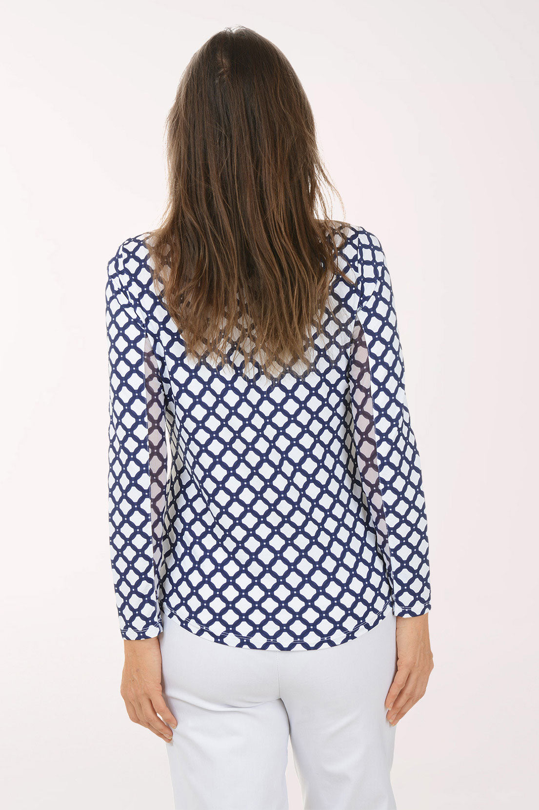 Woman wearing a blue and white patterned shirt on a white background