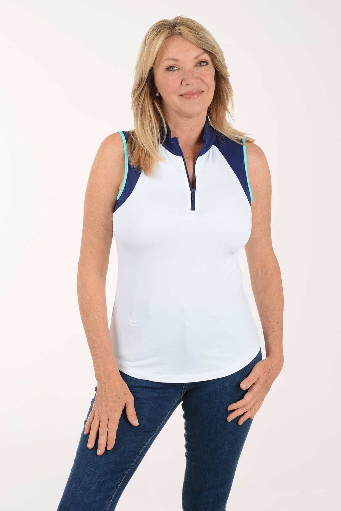 Woman wearing a sleeveless white top with navy accents on a white background