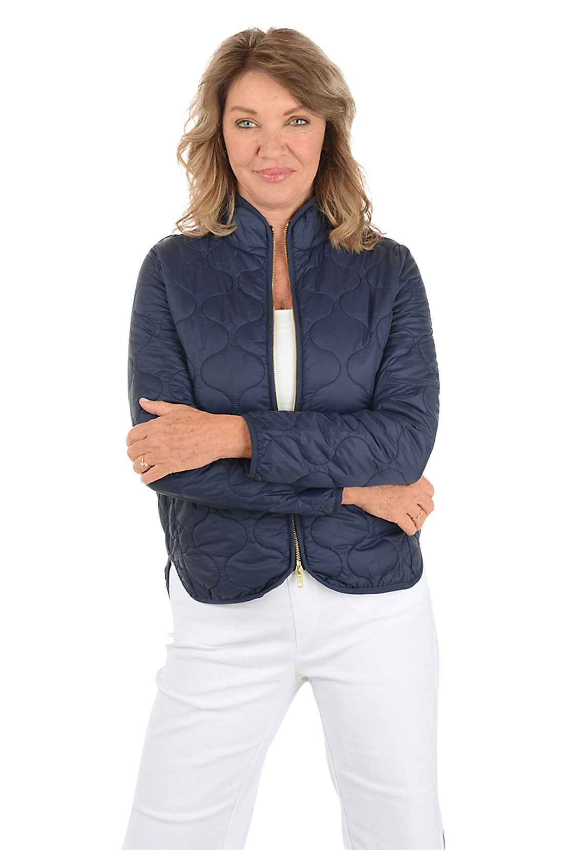 A woman wearing a navy quilted puffer jacket.