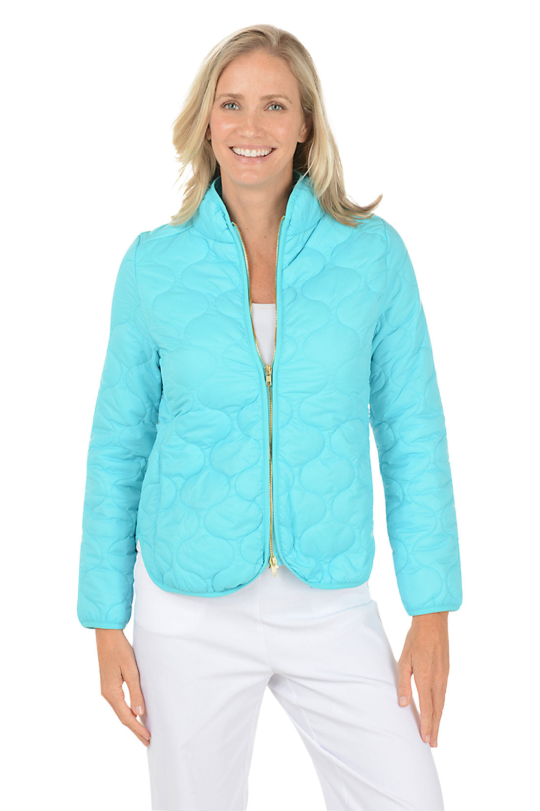 A woman wearing an aqua quilted puffer jacket.
