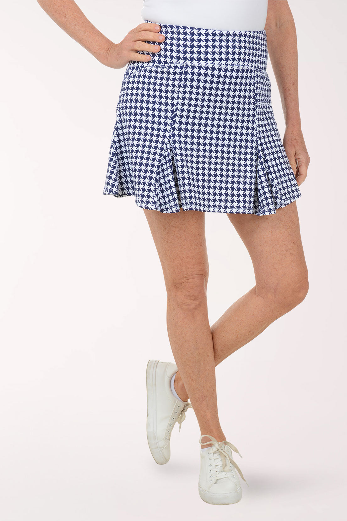 Person wearing a blue and white checkered skirt on a white background