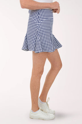 Person wearing a blue and white checkered skirt on a white background