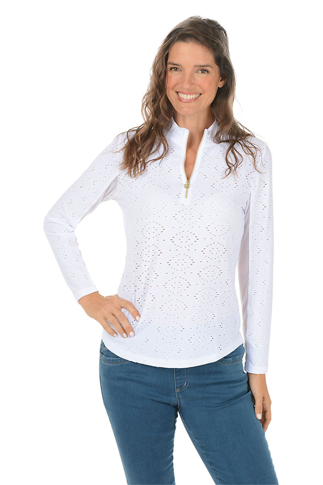 Woman wearing a white long-sleeve top with a pattern and blue jeans on a white background.