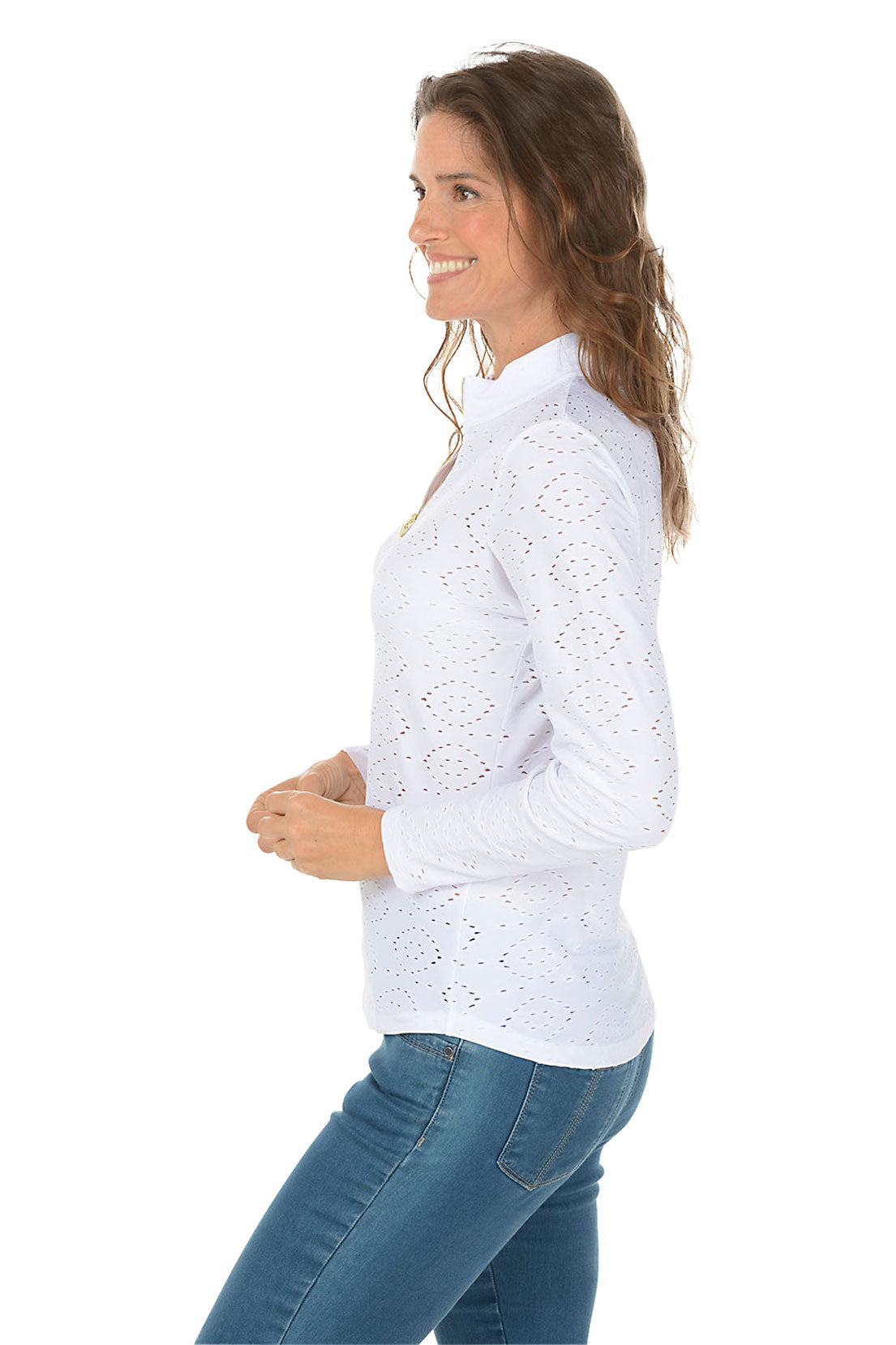 Woman wearing a white long-sleeve top with a subtle pattern on a white background. Side shot.