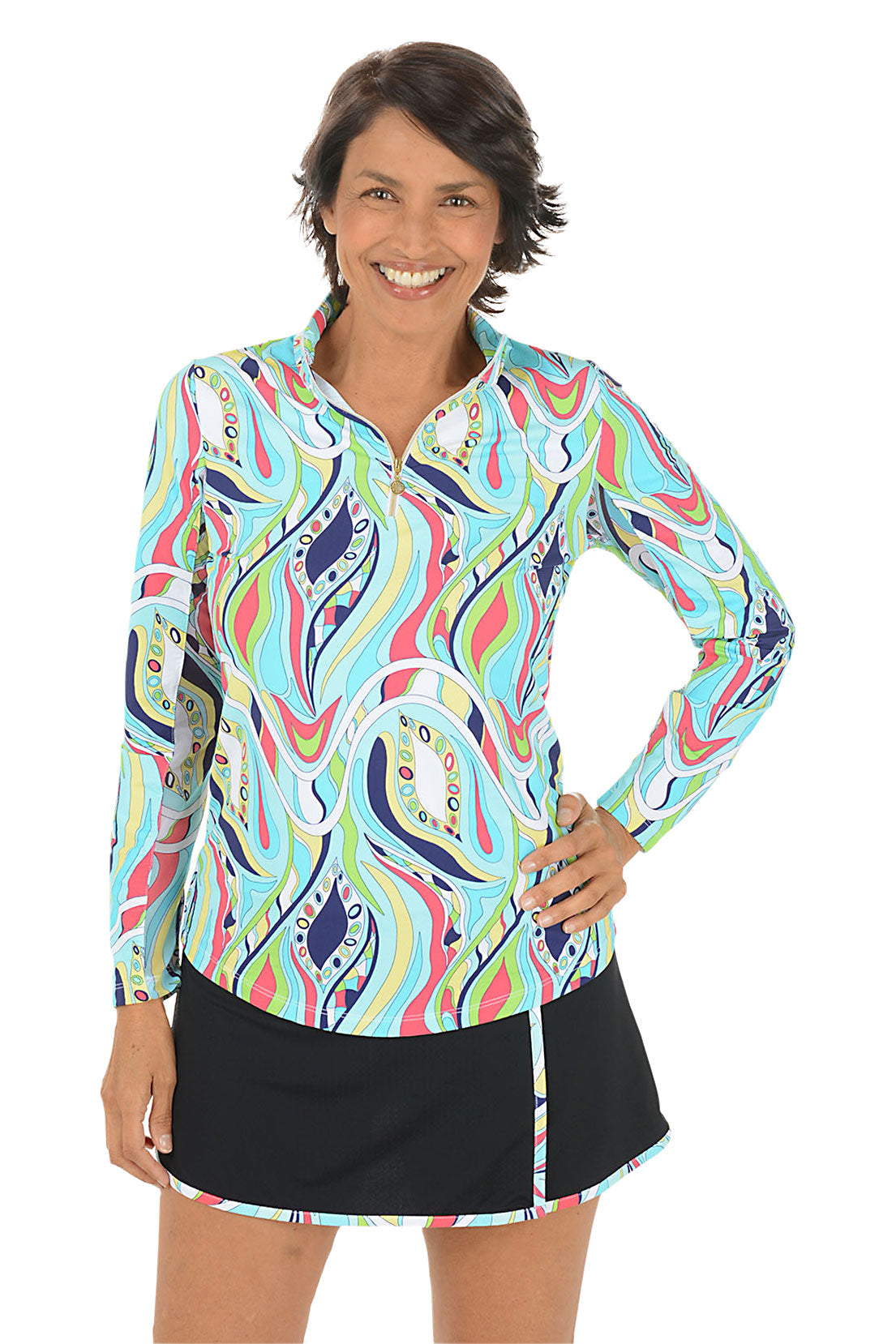 Woman wearing a colorful patterned long-sleeve shirt and black skirt on a white background.