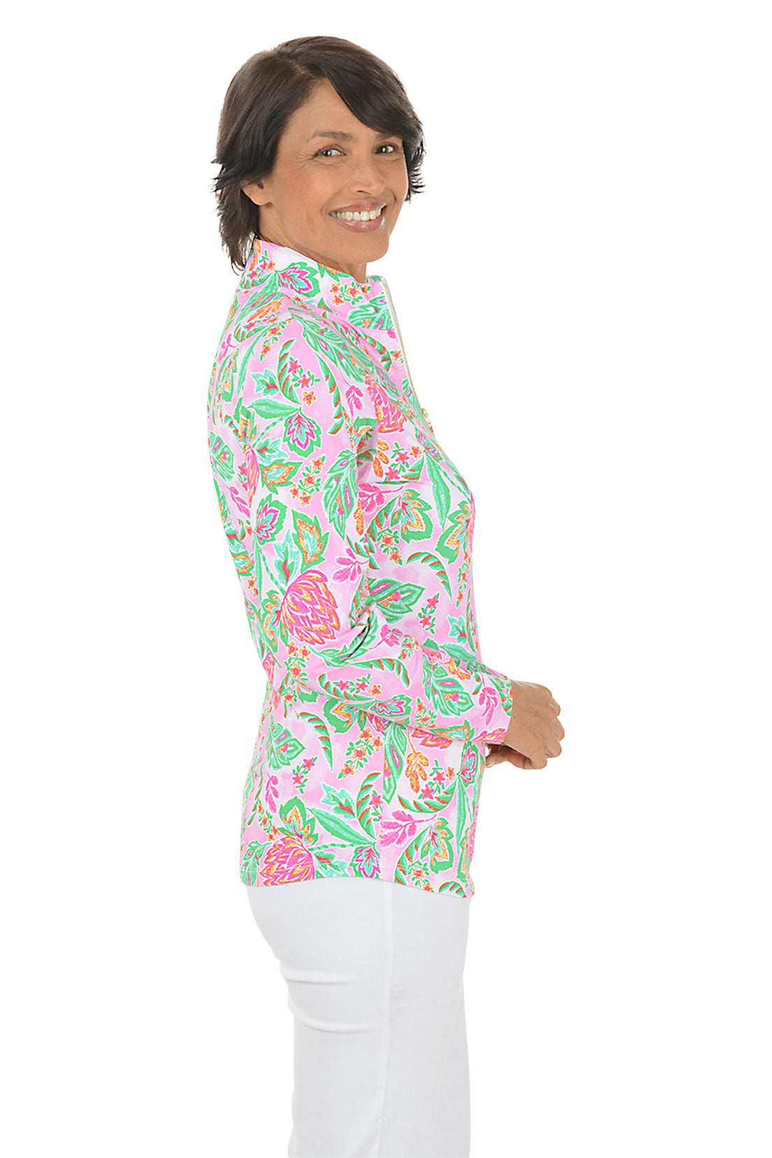 Woman wearing a colorful floral blouse on a white background. Side shot.