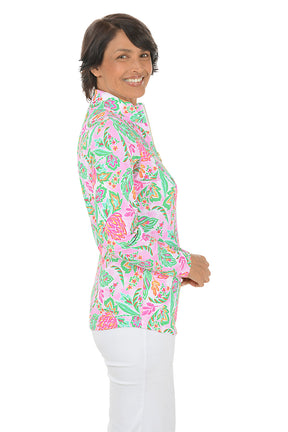 Woman wearing a colorful floral blouse on a white background. Side shot.