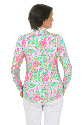 Woman wearing a colorful floral blouse on a white background. Back shot.