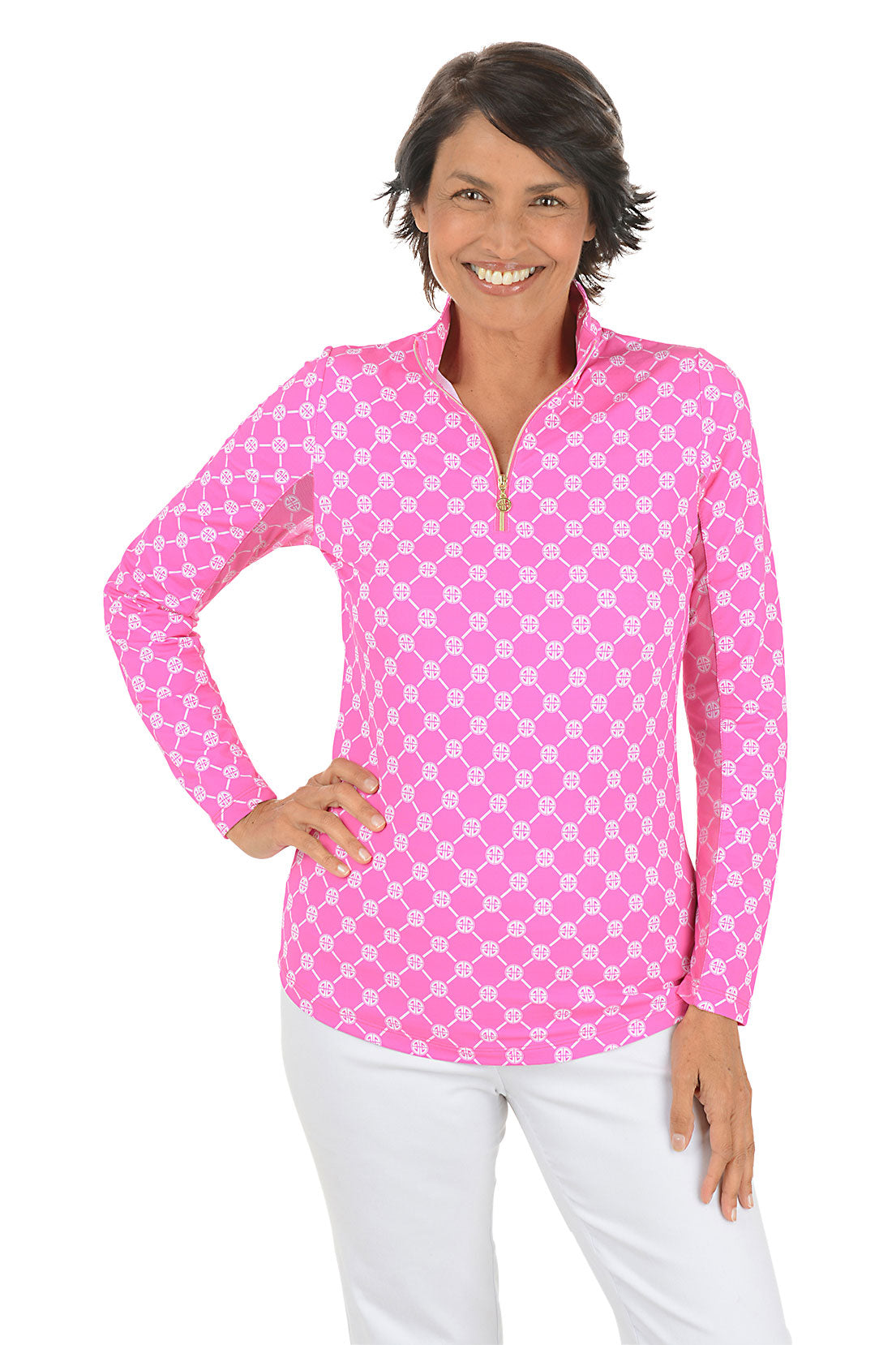 Woman wearing a pink geo-patterned long-sleeve shirt with a white background.