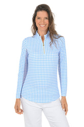 Woman wearing a blue and white checkered long-sleeve shirt with mesh sleeves on a white background.