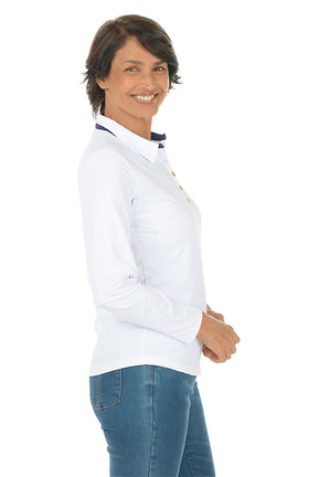 Woman wearing a white long-sleeve shirt and blue jeans on a white background. Side shot.