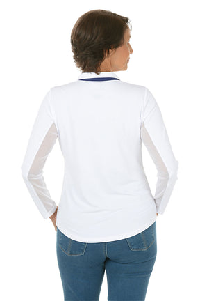 Woman wearing a white long-sleeve shirt and blue jeans on a white background. Back shot.