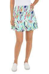 Person wearing a colorful patterned skirt on a white background.
