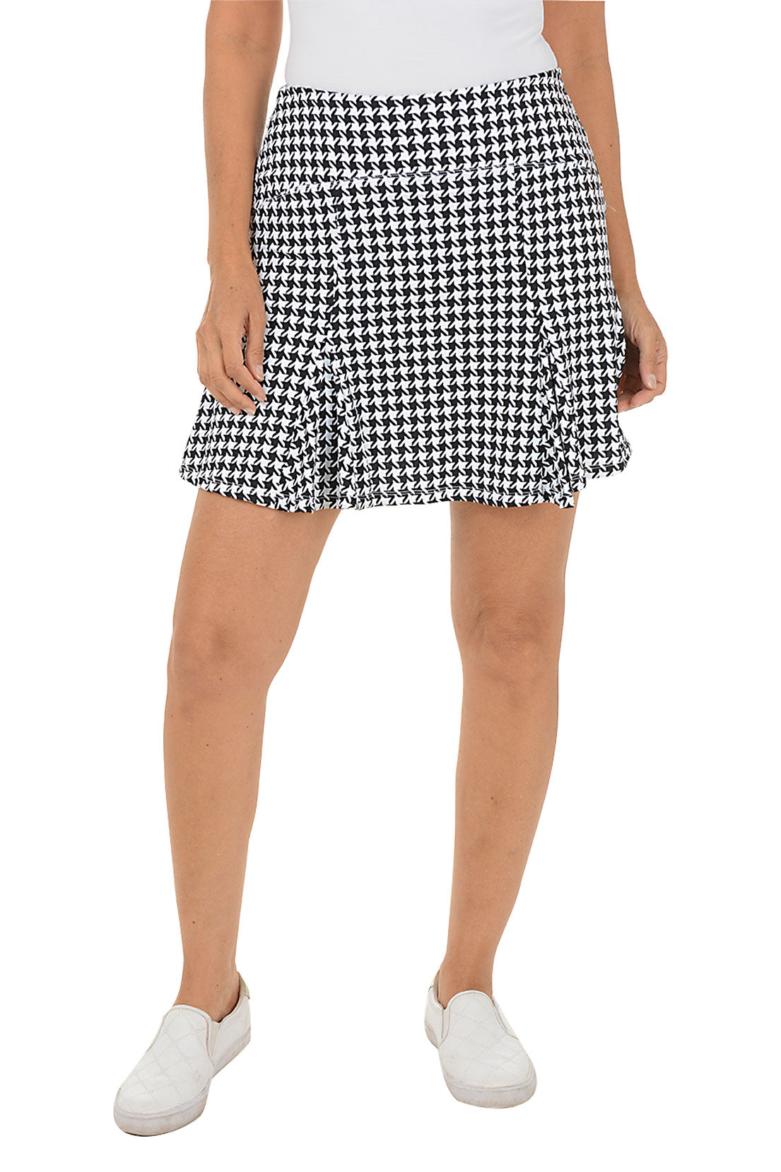 Person wearing a black and white checkered skirt on a white background
