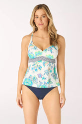 Woman wearing a floral tankini set on a white background