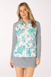 Woman wearing a floral rash guard with a patterned collar on a white background