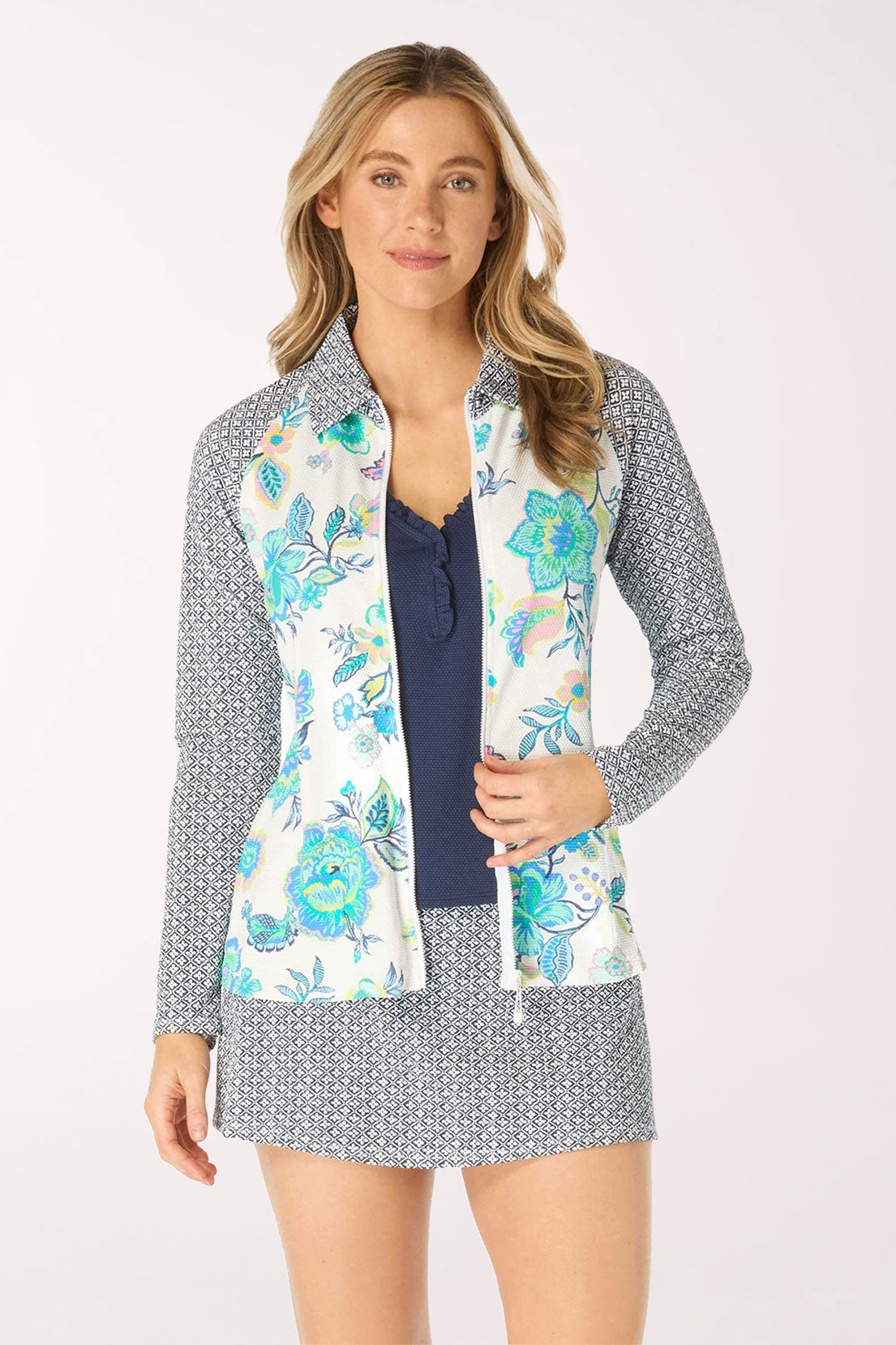 Woman wearing a floral rash guard with a patterned collar on a white background