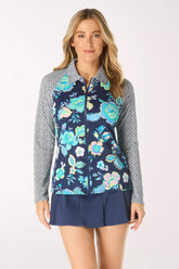 Woman wearing a navy floral rash guard with a patterned collar on a white background
