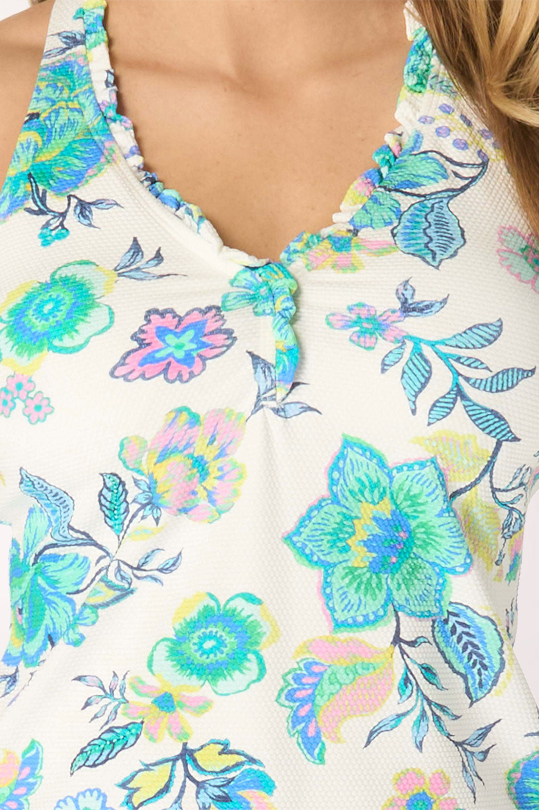 Close-up of a floral-patterned top with colorful flowers on a white background
