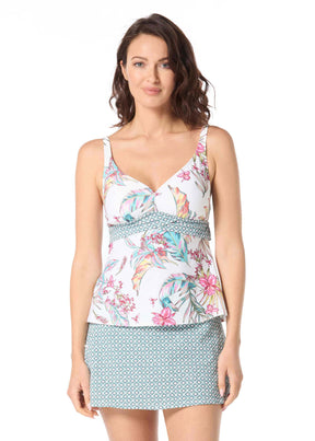 Woman wearing a floral top and patterned skirt on a white background