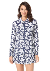 Woman wearing a navy floral dress on a white background