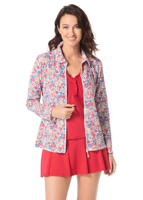 Woman wearing a floral jacket over a red dress on a white background
