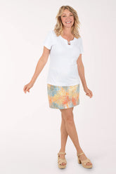 Woman wearing a multicolored tropical print skort.