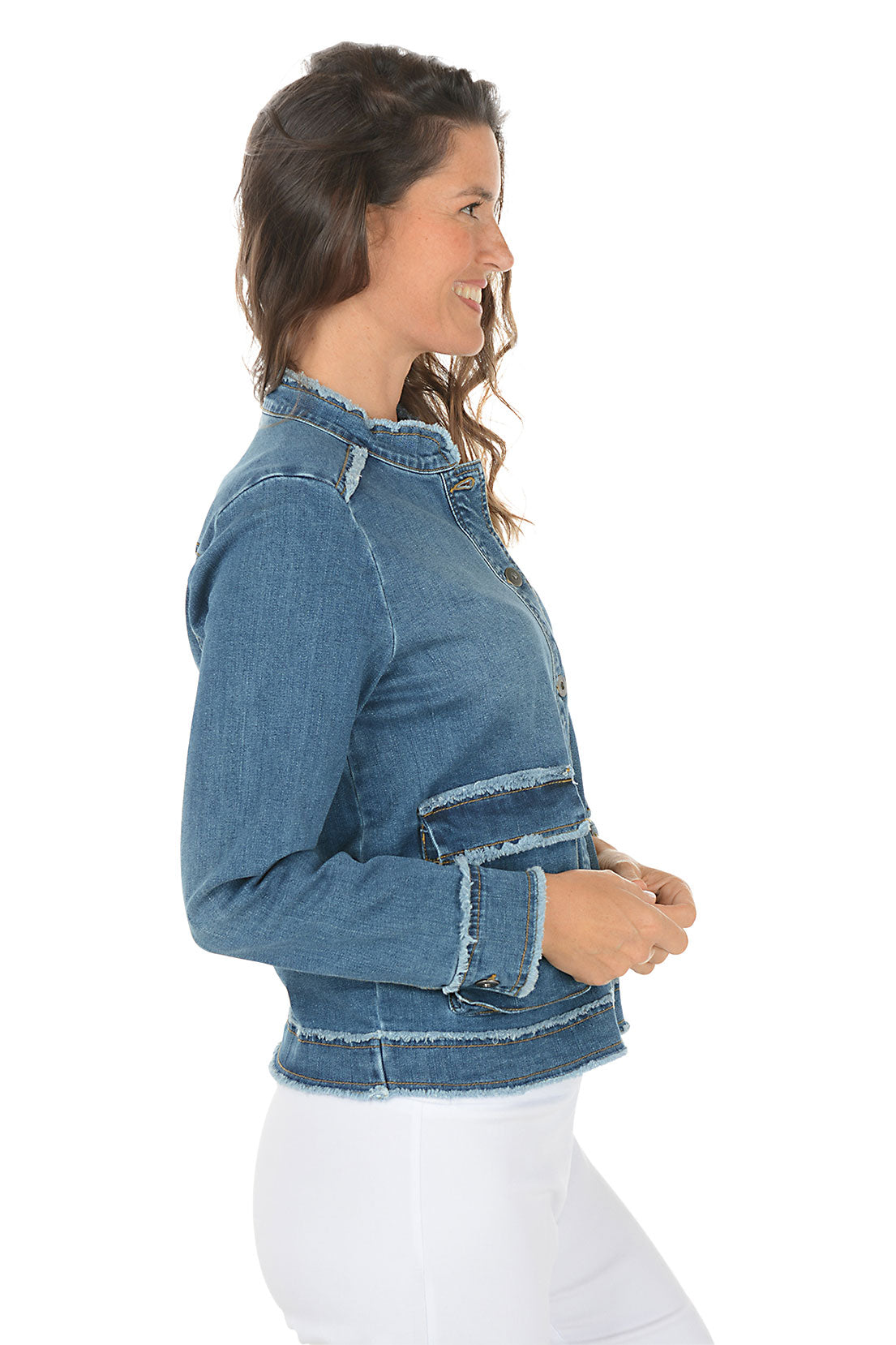 Woman wearing a blue denim jacket on a white background. Side shot.