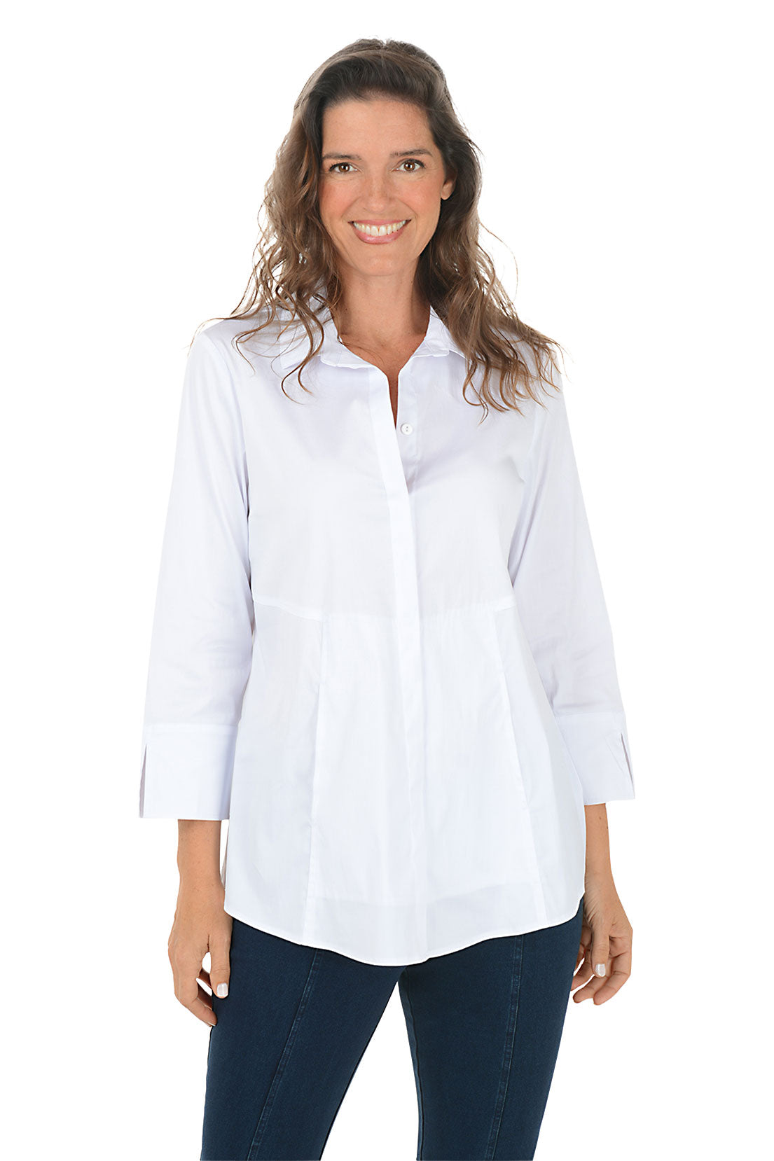 Woman wearing a white collared button down shirt and dark denim pants on a white background.
