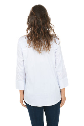 Woman wearing a white collared button down shirt and dark denim pants on a white background. Back shot.