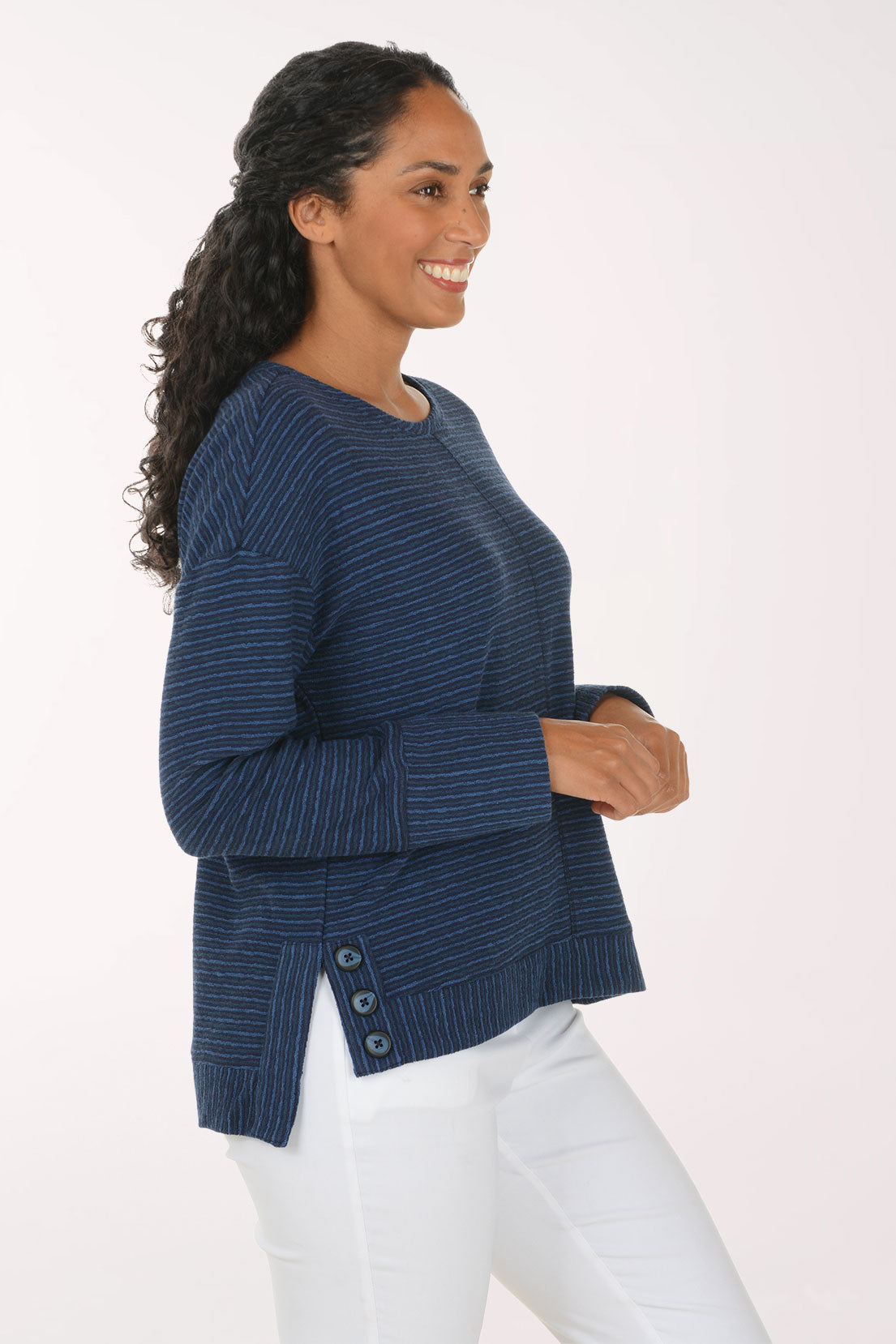 Woman wearing a blue striped long sleeve pullover top
