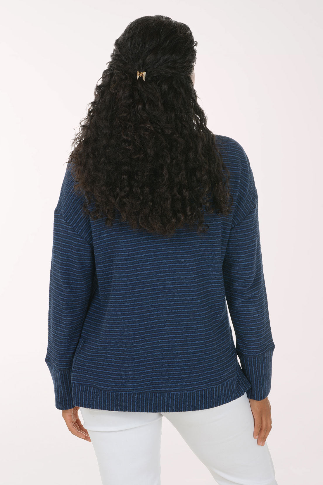 Woman wearing a blue striped long sleeve pullover top