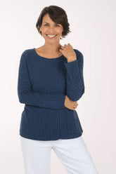 Woman wearing a blue striped long sleeve shirt 