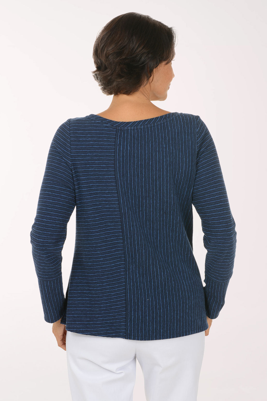 Woman wearing a blue striped long sleeve shirt 