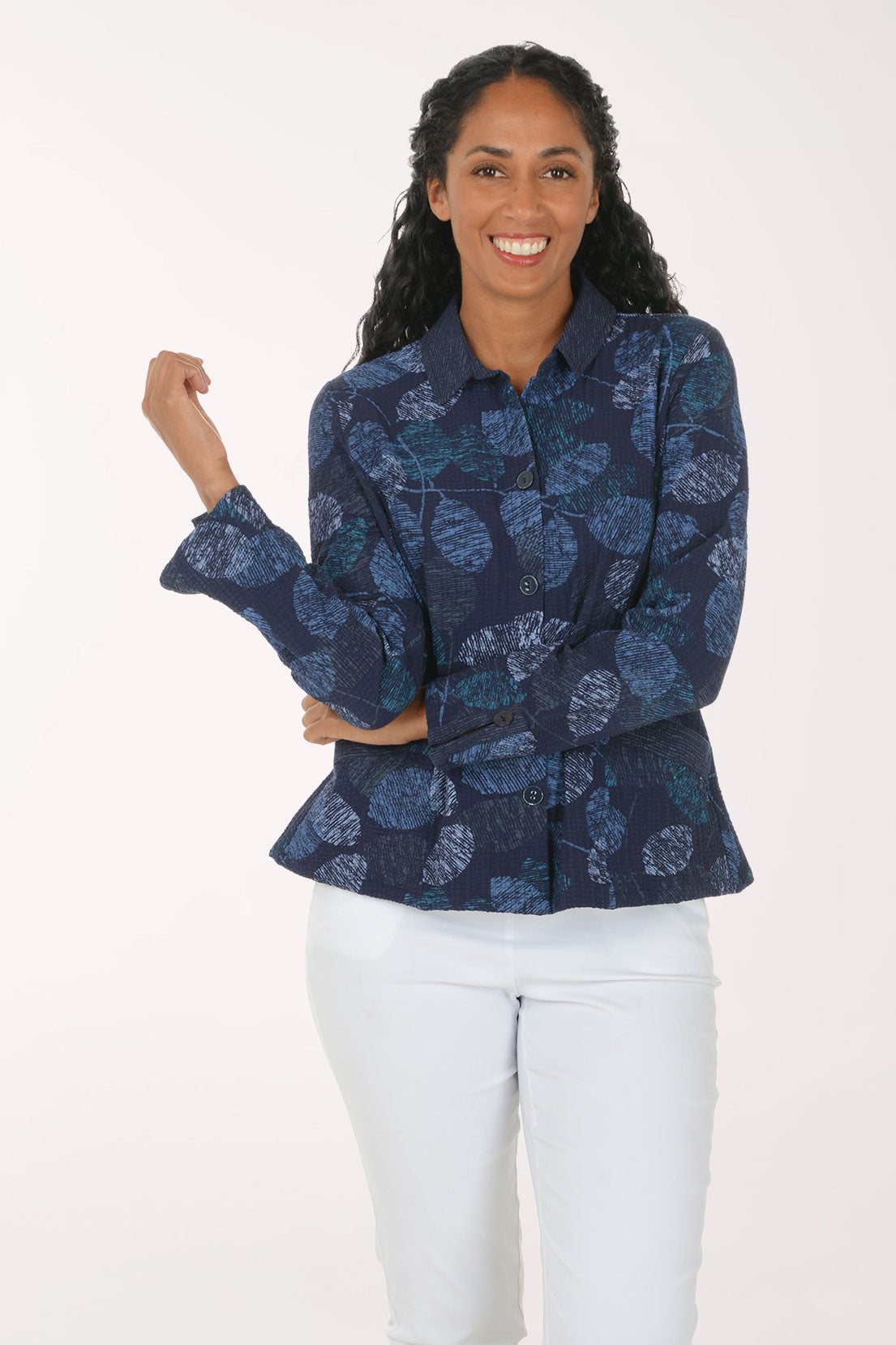Woman wearing a blue leaf printed button down jacket