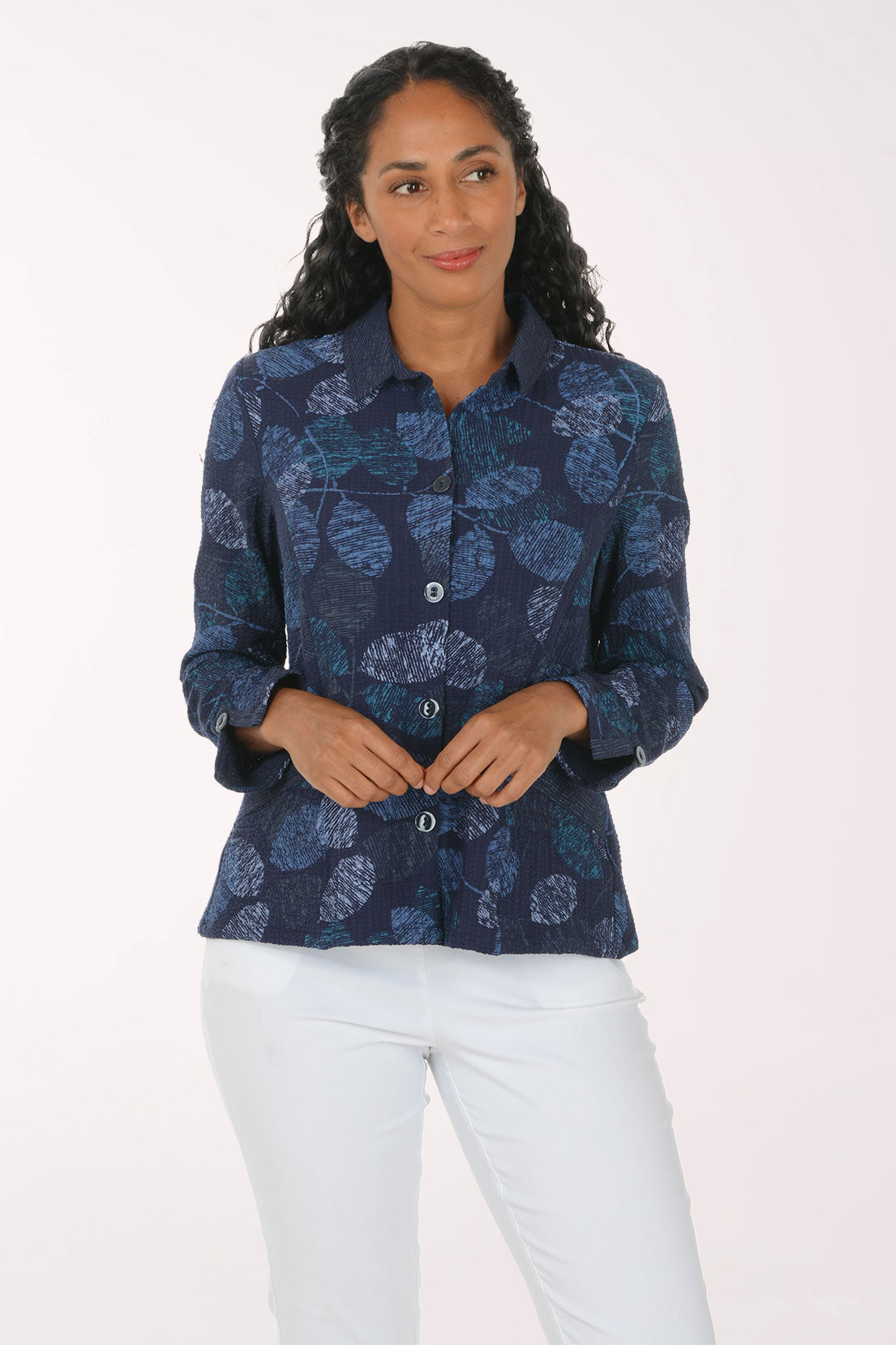Woman wearing a blue leaf printed button down jacket