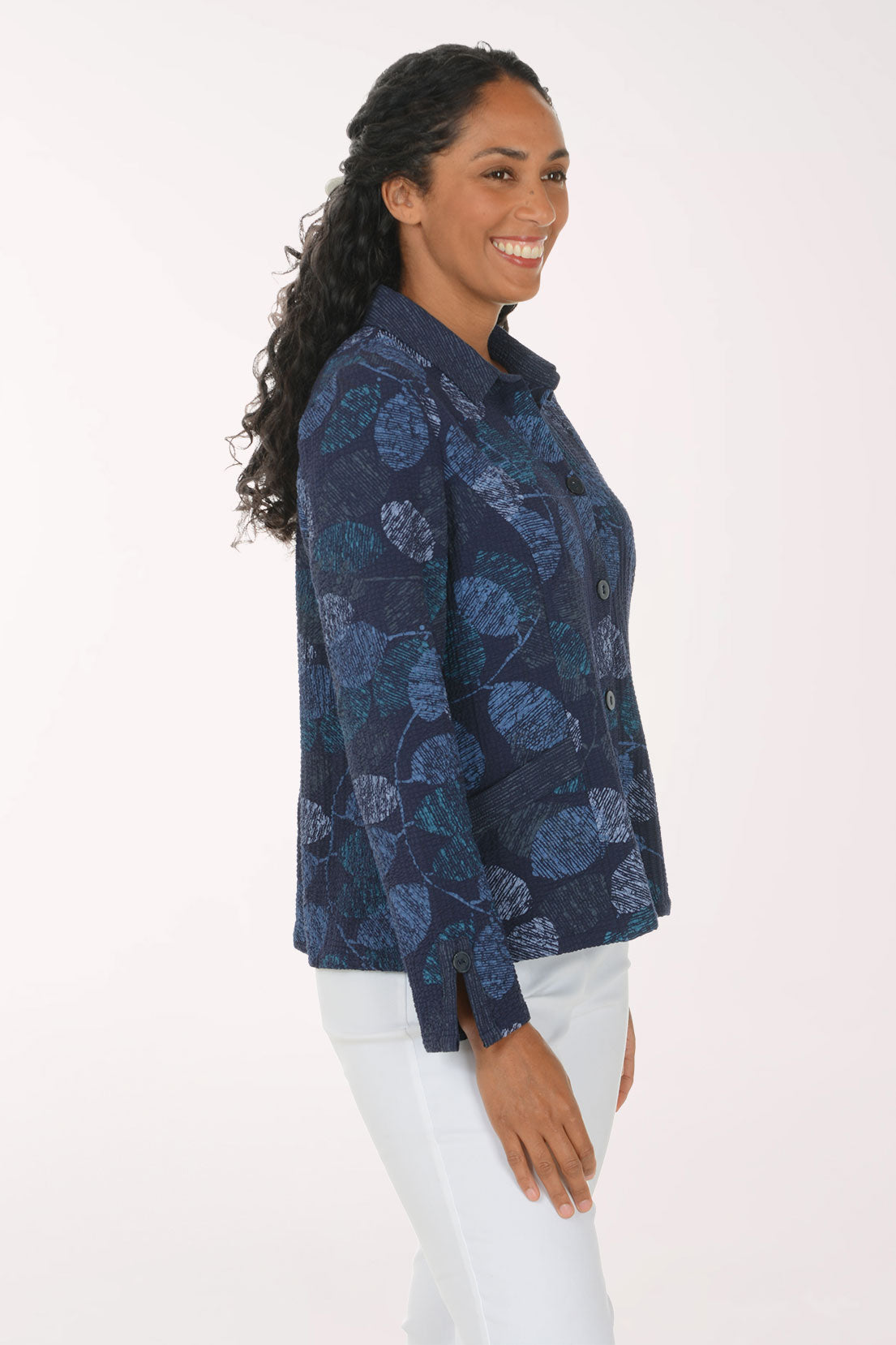 Woman wearing a blue leaf printed button down jacket