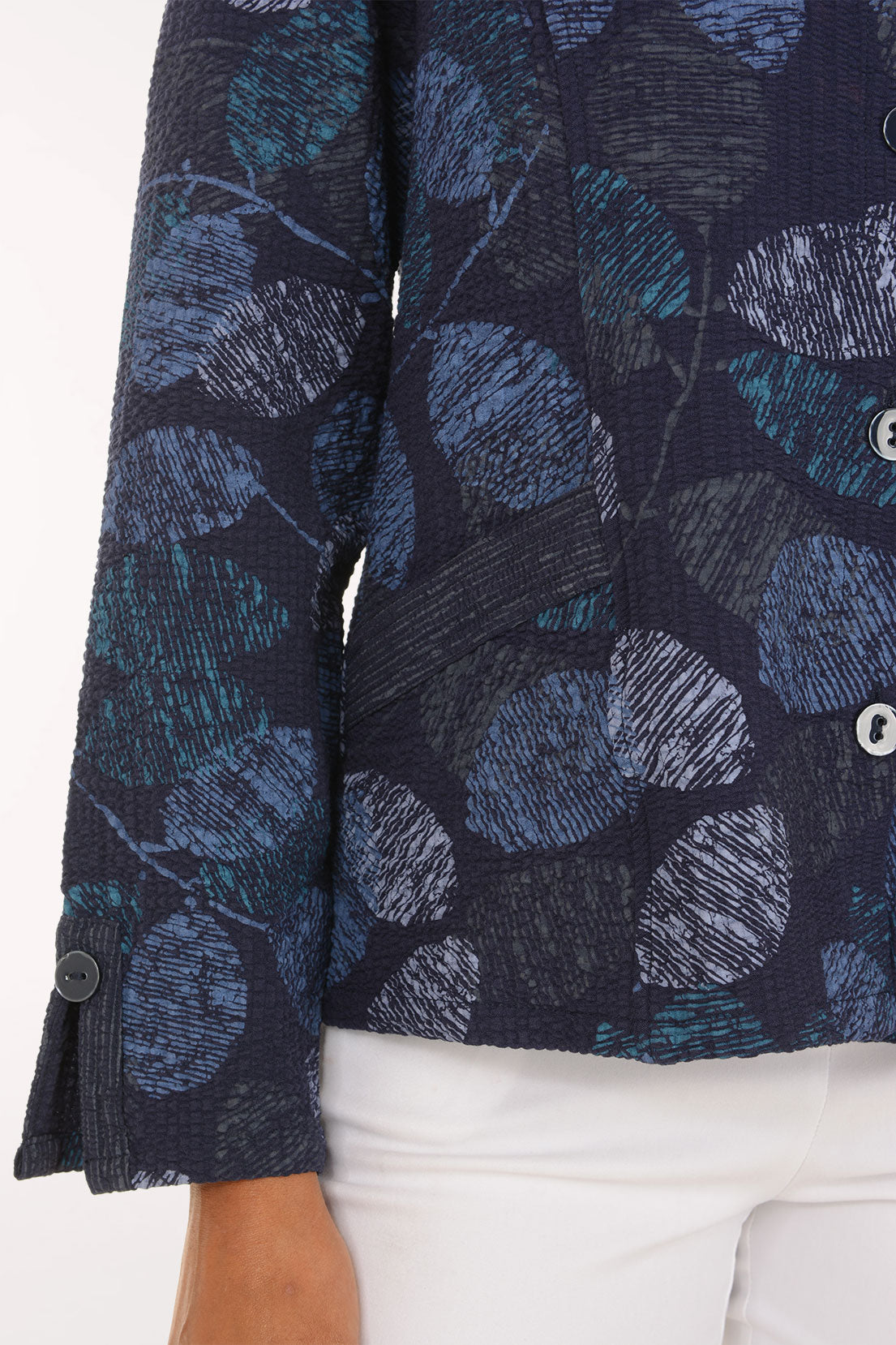 Woman wearing a blue leaf printed button down jacket