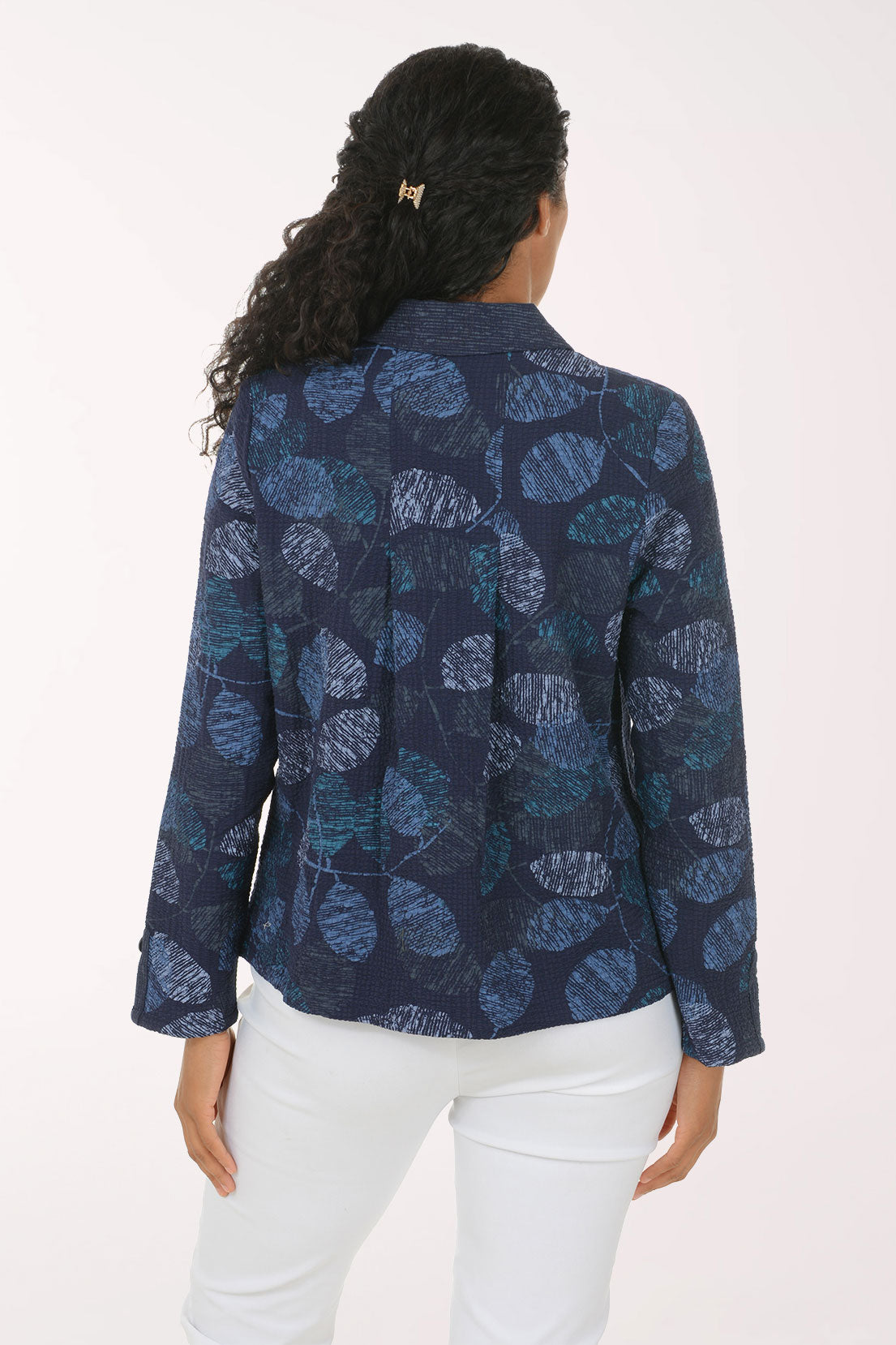Woman wearing a blue leaf printed button down jacket
