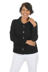 Woman wearing a black collared jacket with button details on a white background.