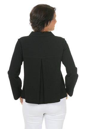 Woman wearing a black collared jacket with button details on a white background. Back shot.