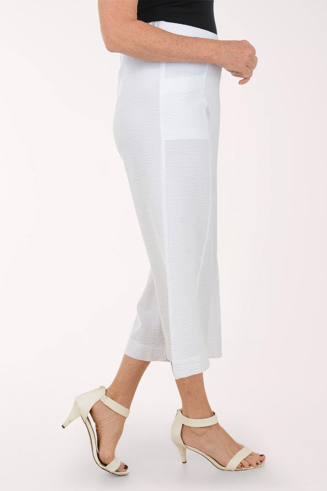 White wide-leg pants worn by a person on a white background