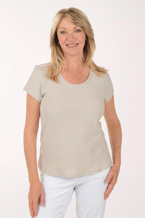 Woman wearing a beige striped shirt and white pants on a white background