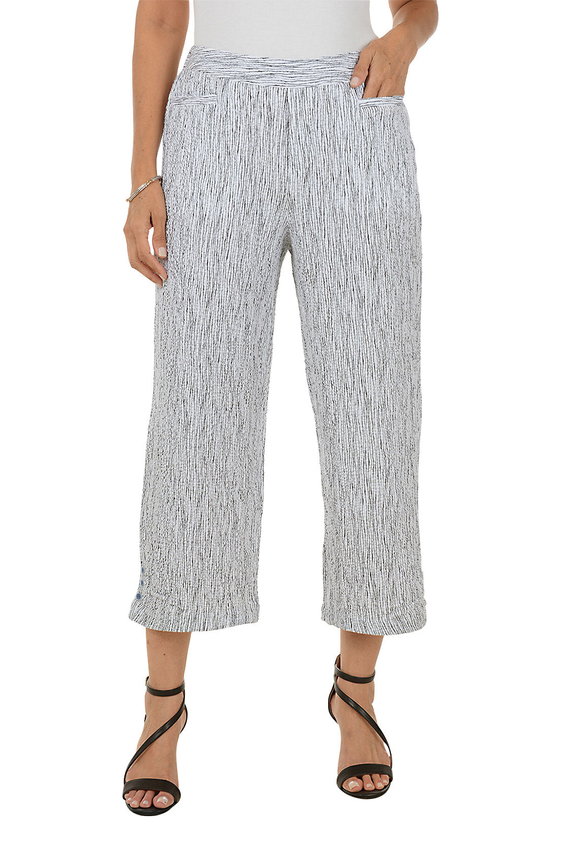 Woman wearing a patterned wide-leg pants on a white background