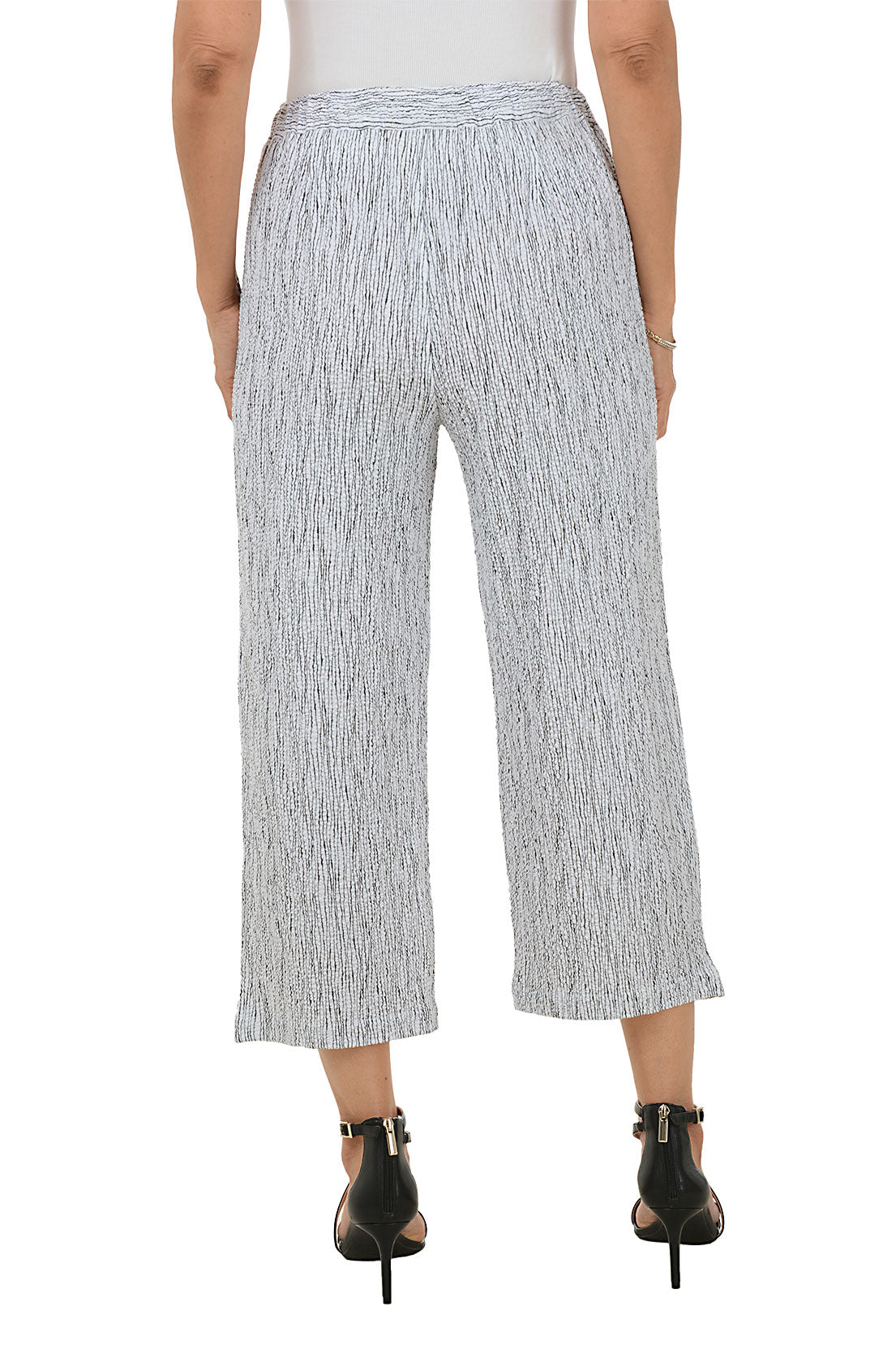 Woman wearing a patterned wide-leg pants on a white background