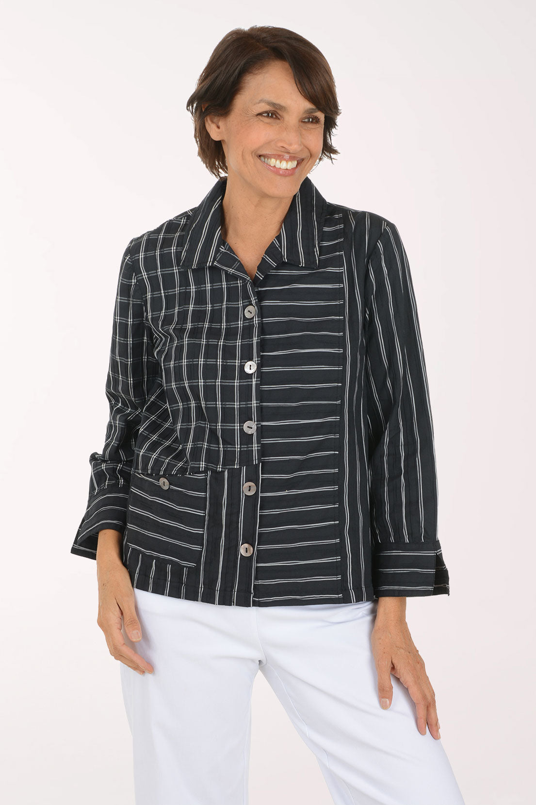 Woman wearing a black and white striped button down shirt 