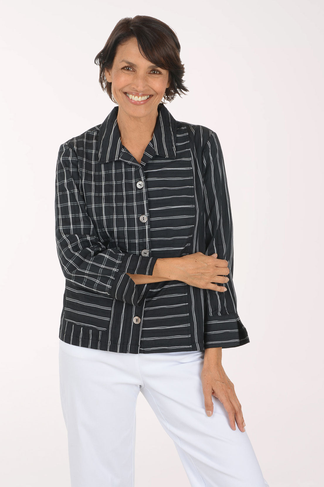Woman wearing a black and white striped button down shirt 