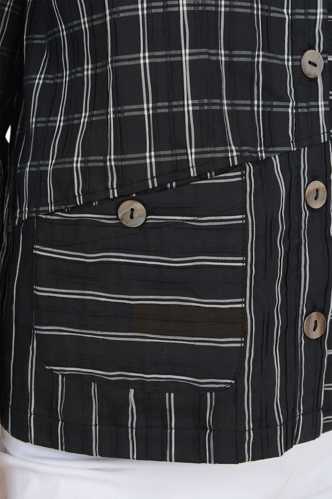 Woman wearing a black and white striped button down shirt 