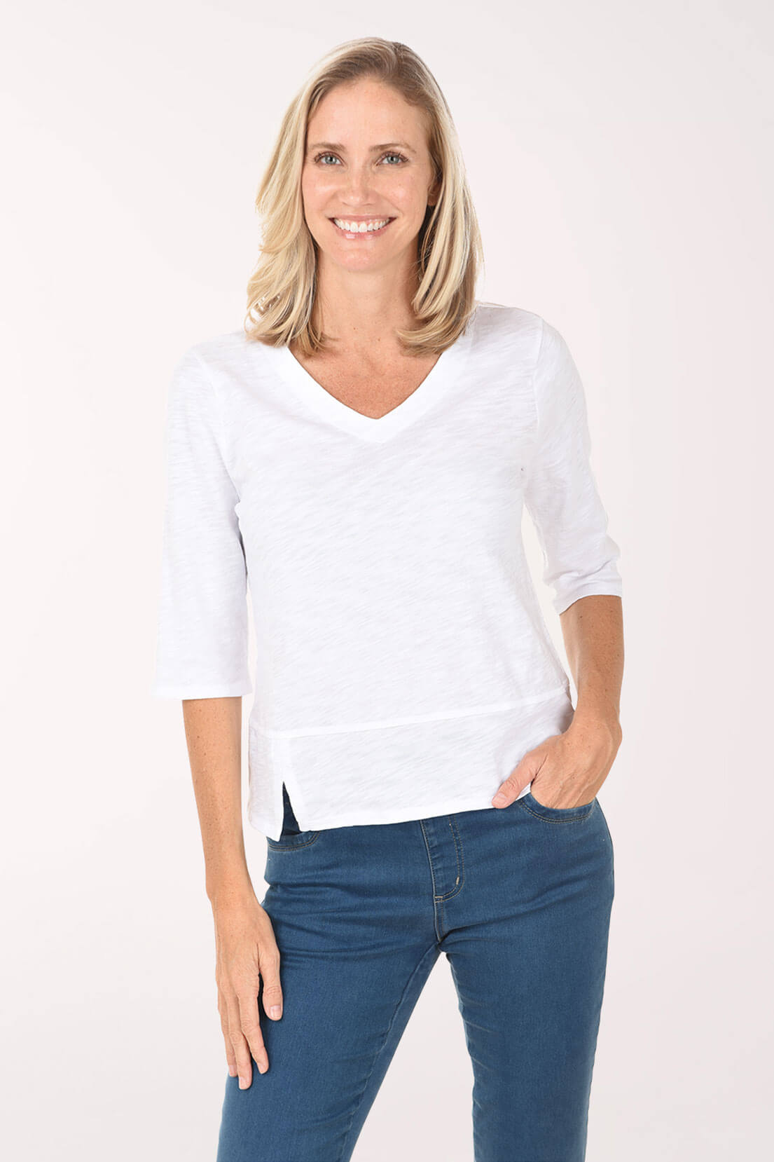 Woman wearing a white shirt and blue jeans on a white background